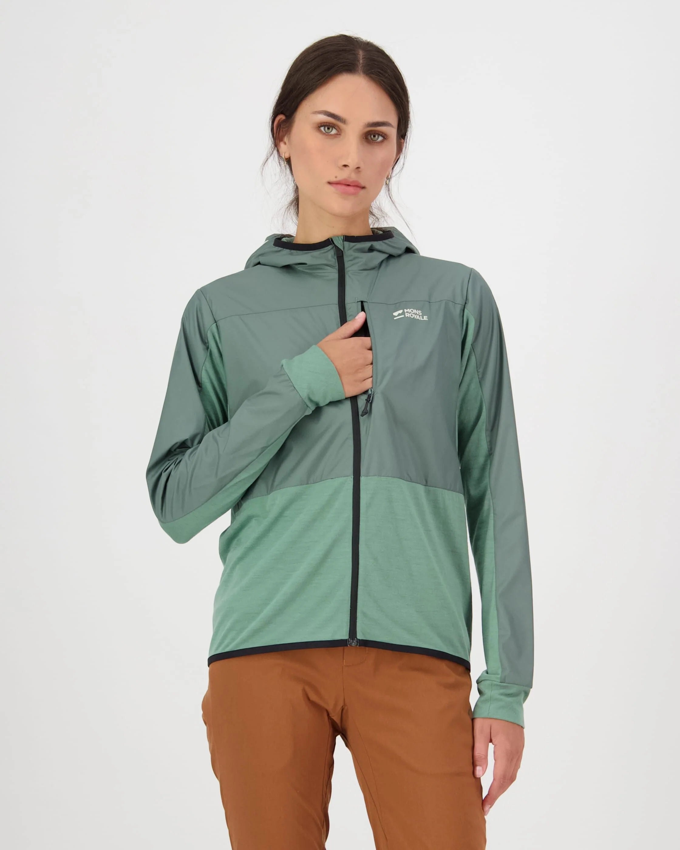 Woman wearing a green and gray jacket with a visible brand logo on a white background