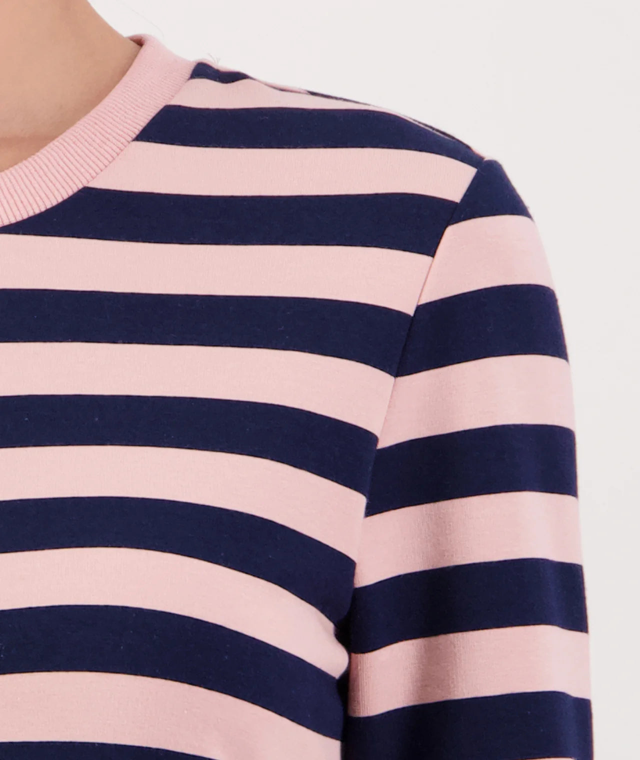 Close-up of a pink and navy striped sweater on a white background