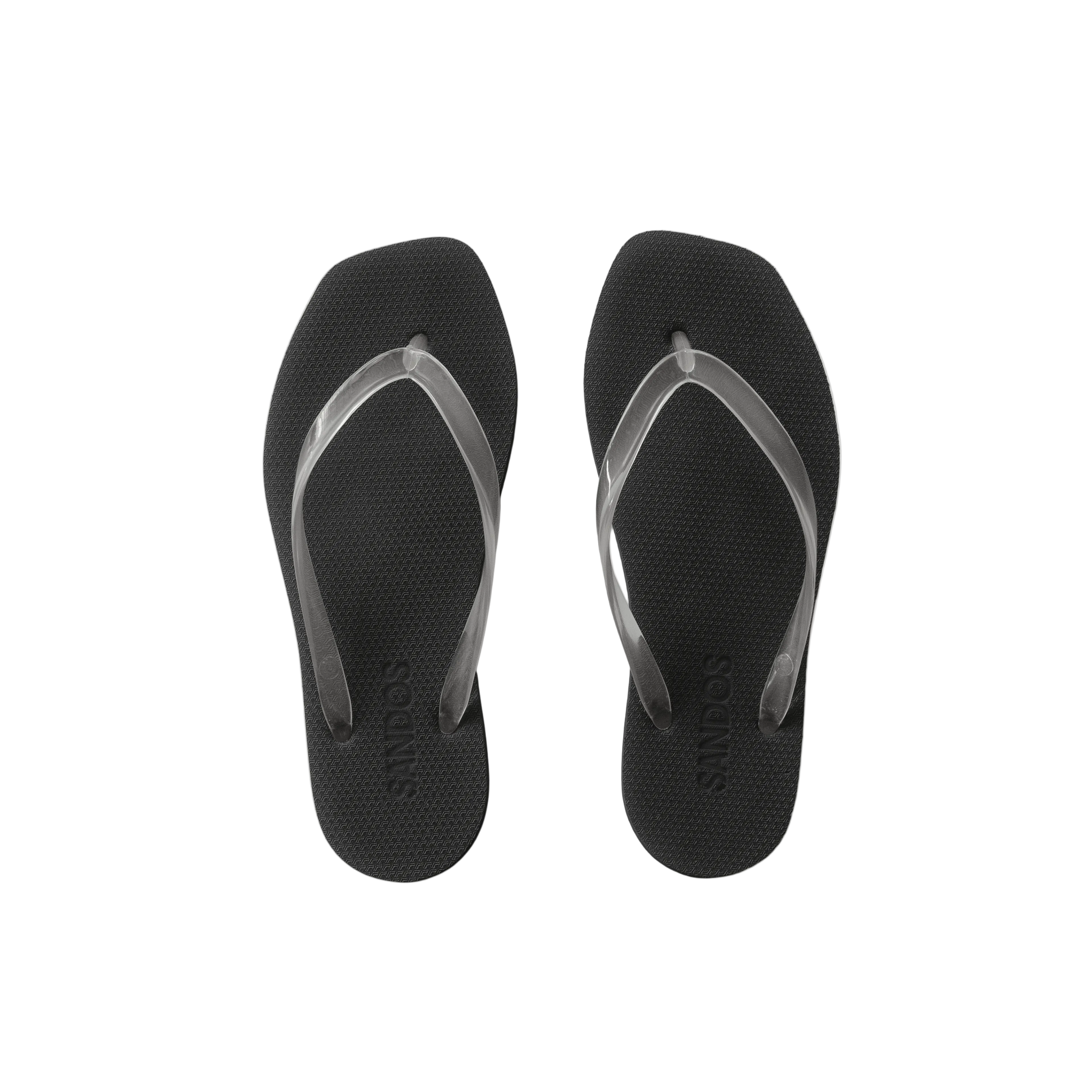 Black flip-flops with clear straps on a beige background