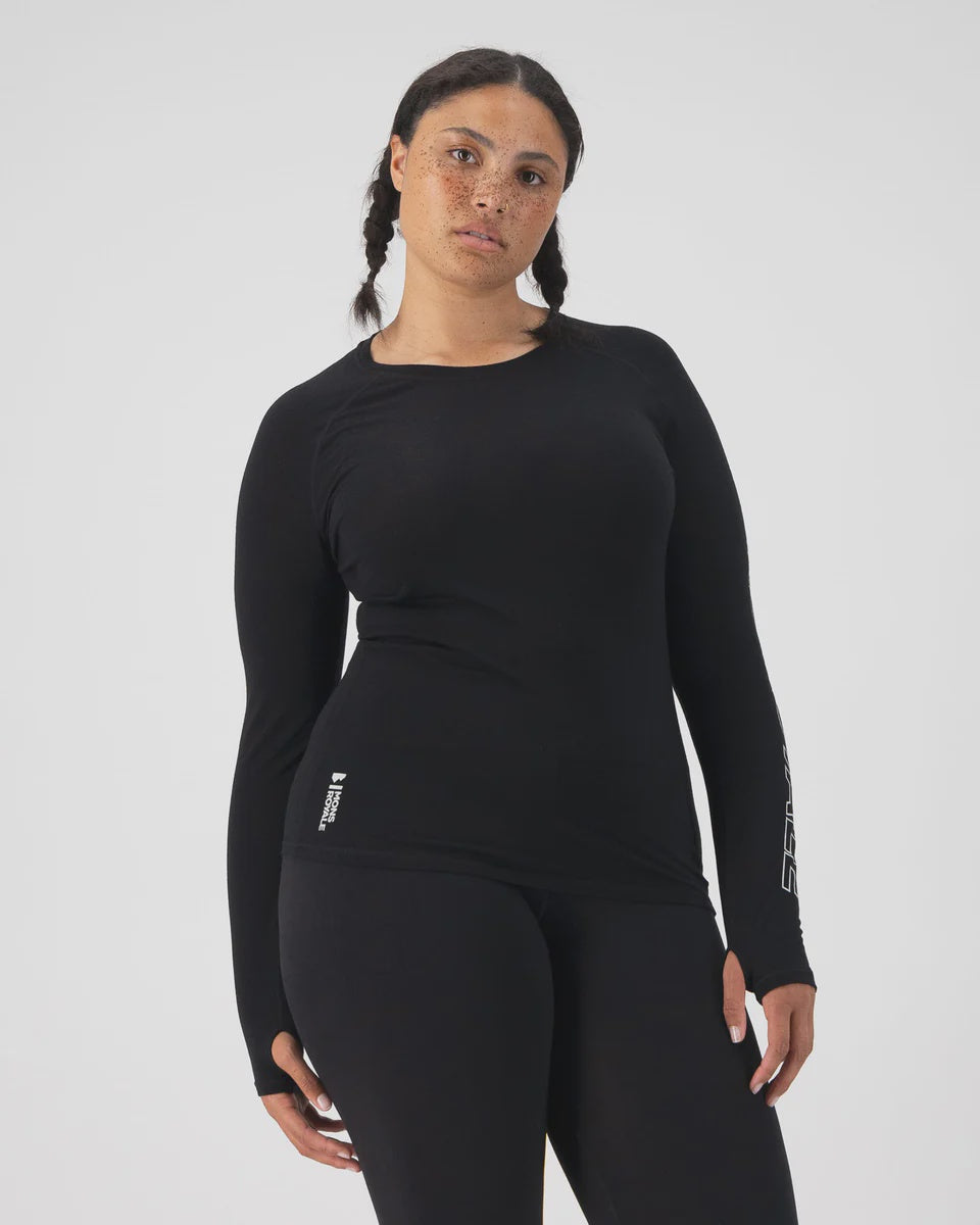 Person wearing a black long-sleeve athletic top and leggings on a white background
