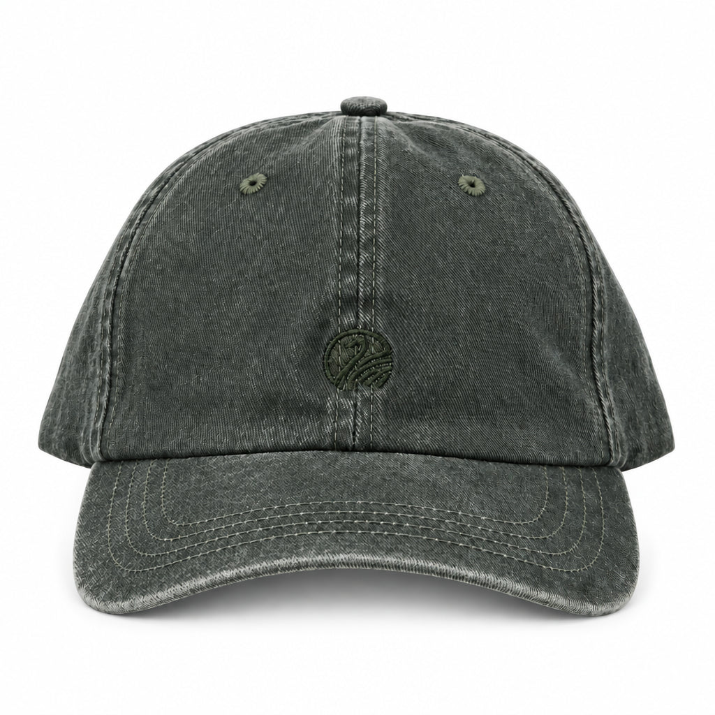 A washed dark green baseball cap with a curved brim and a small embroidered logo on the front, shown against a plain white background.