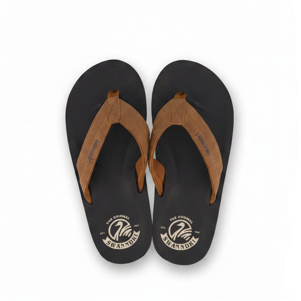 Black and brown flip-flops with Swanndri logo on a light gray background