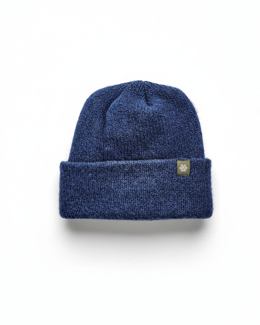 Blue knit beanie with a Norsewear ogo on a white background