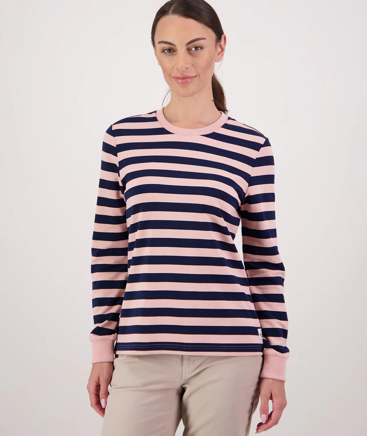 Woman wearing a pink and navy striped sweater on a white background