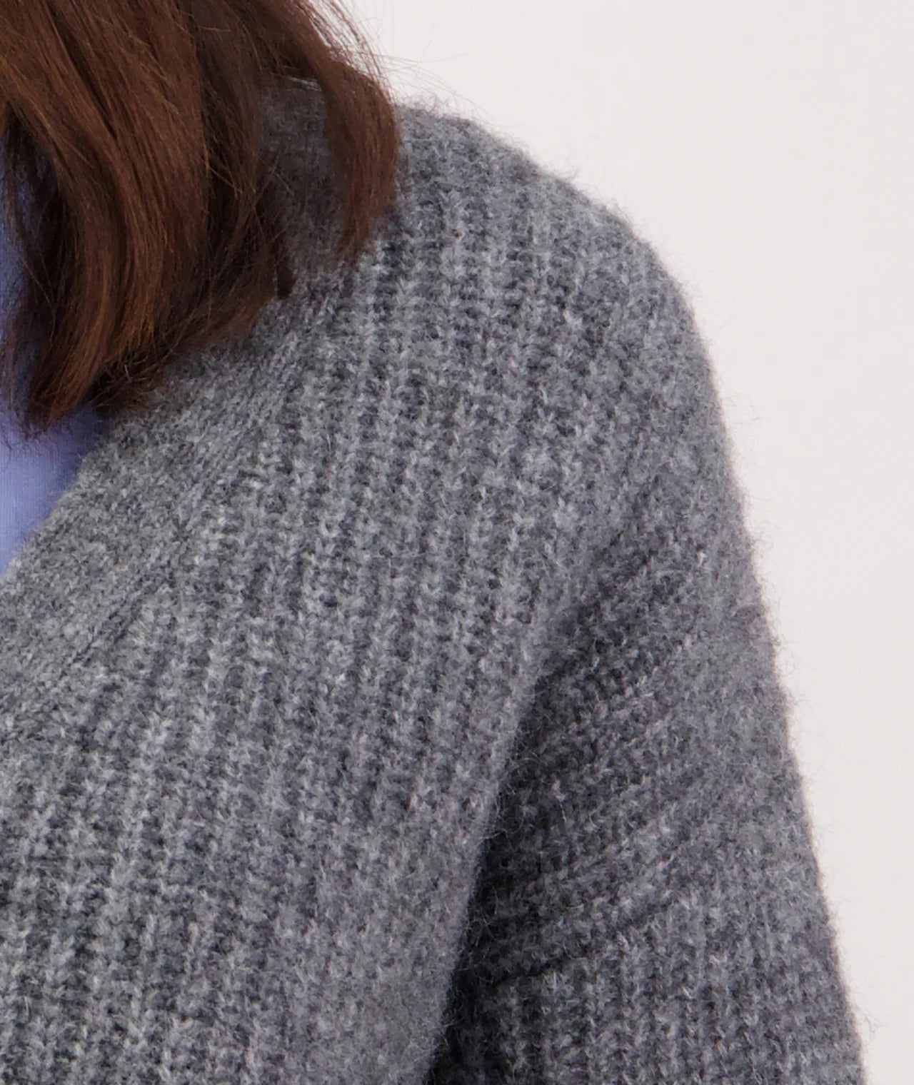 Close-up of a textured gray sweater on a white background