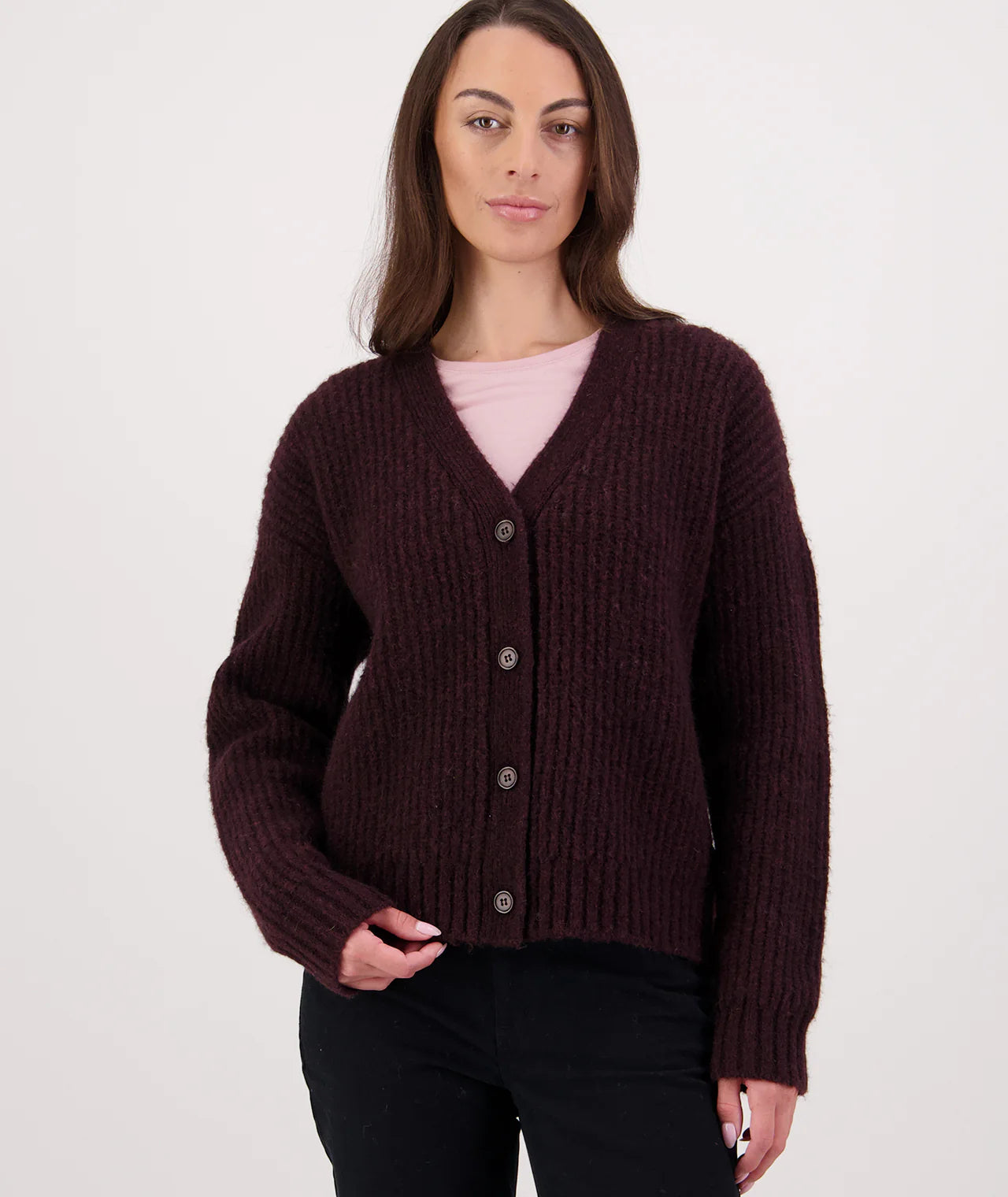 Woman wearing a Shiraz coloured cardigan over a pink shirt on a white background