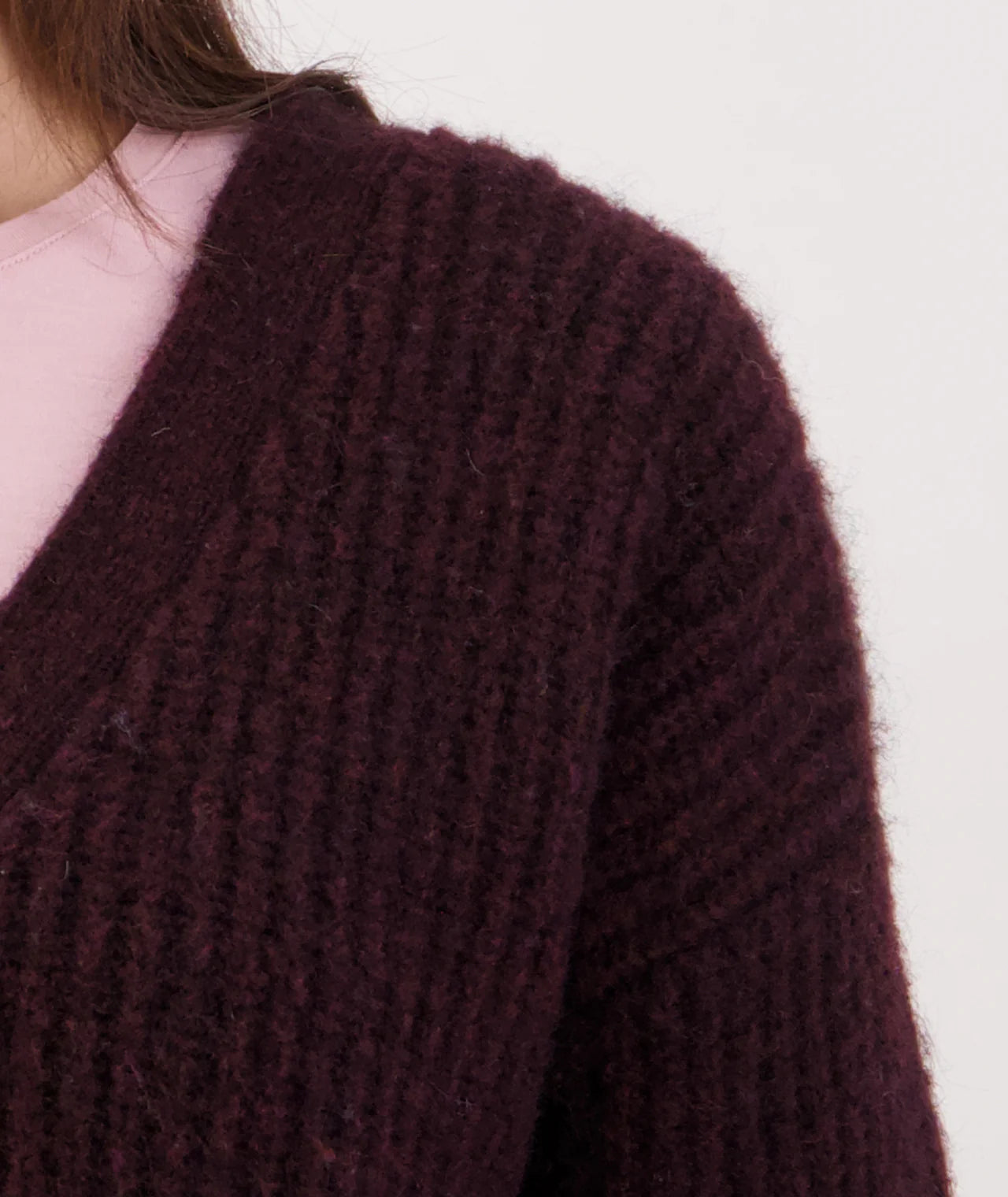 Close-up of a shiraz knitted sweater on a plain background