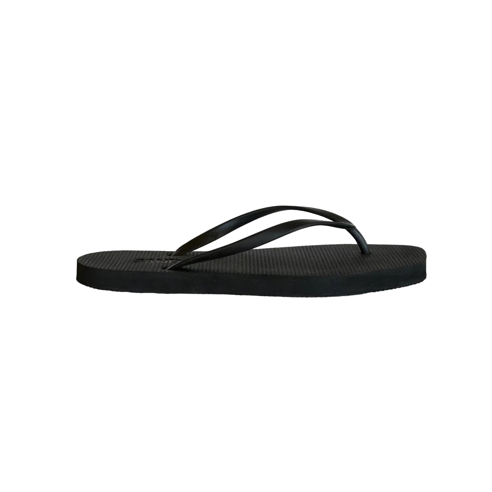 Black sandal on a light beige background