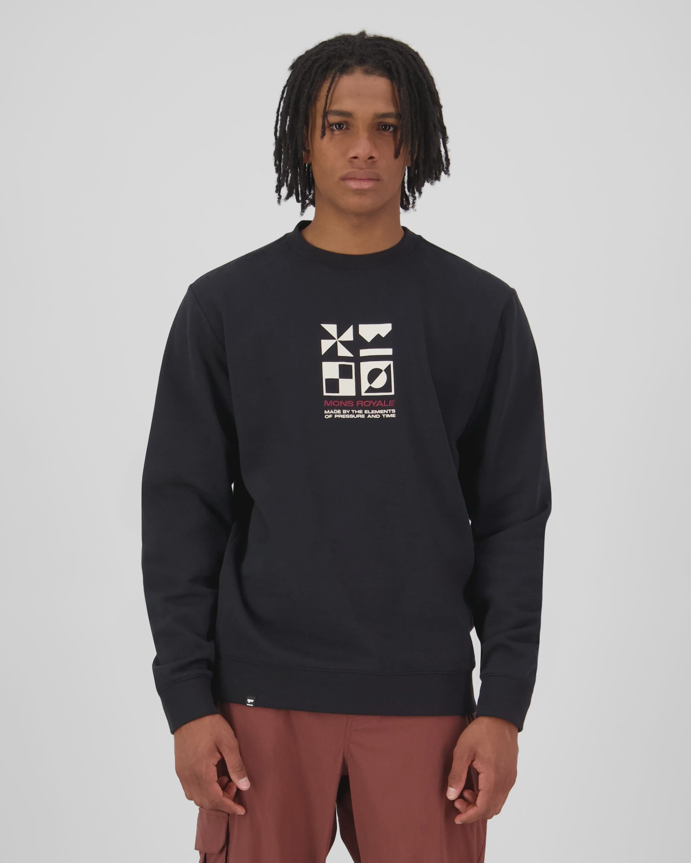 Person wearing a black sweatshirt with a Mons Royale logo.