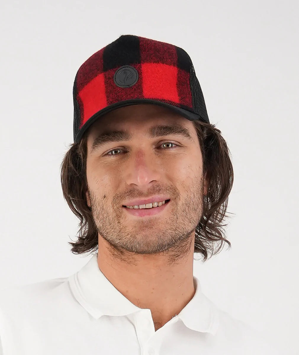 Man wearing a red and black checkered cap on a white background