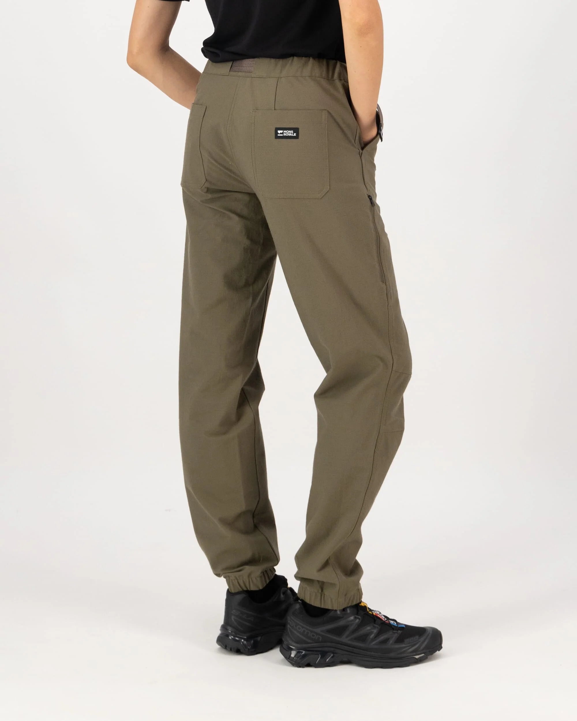 Person wearing olive green pants on a white background
