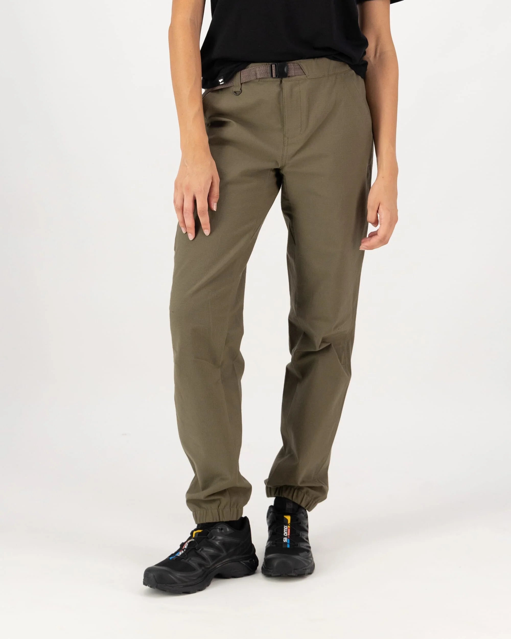 Person wearing olive green pants on a white background